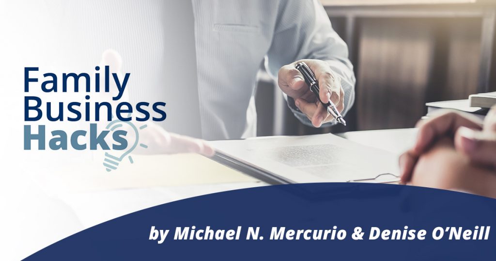 Family Business Hacks logo on left side of photo with a man holding a pen and signing an agreement on paper- by Michael N. Mercurio & Denise O'Neill