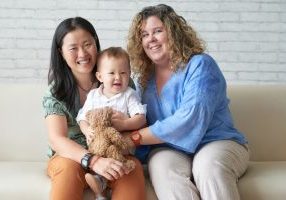 Happy,Multi-ethnic,Female,Couple,With,Their,Adorable,Baby,Boy