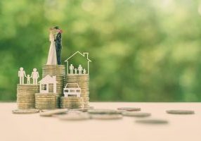 Sustainable financial goal for family life or married life concept : Miniature wedding couple, parent & child, a house or home, a car on rows of rising coins, depicts savings or growth for new family W