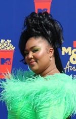 Lizzo at the MTV Movie & TV Awards in a neon green dress.