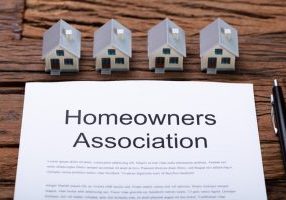 House Model Near HOA Rules And Regulations Document