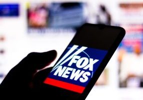 In this photo illustration the Fox News Channel logo seen displayed on a smartphone