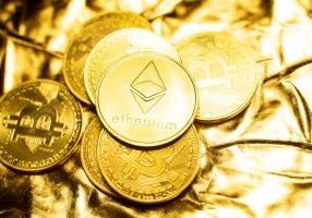 Gold Ethereum and bitcoin coins on a golden background