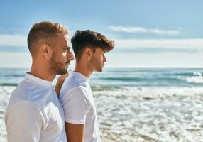 Young,Gay,Couple,With,Serious,Expression,Looking,To,The,Horizon
