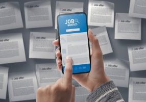 Job search app on smartphone: woman searching for a professional occupation online