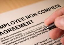 Man signing an employee Non-compete agreement