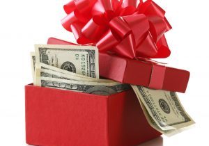 Bundle,Of,Dollars,In,Present,Box,With,Bow,Isolated,On
