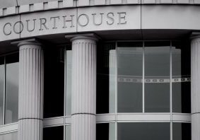 Close-up of front of courthouse. The word "Courthouse" is etched in stone.