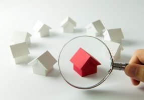 House searching concept with a magnifying glass