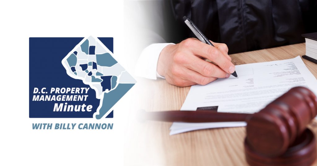 D.C. property management minute with billy cannon with a man signing a document on a table