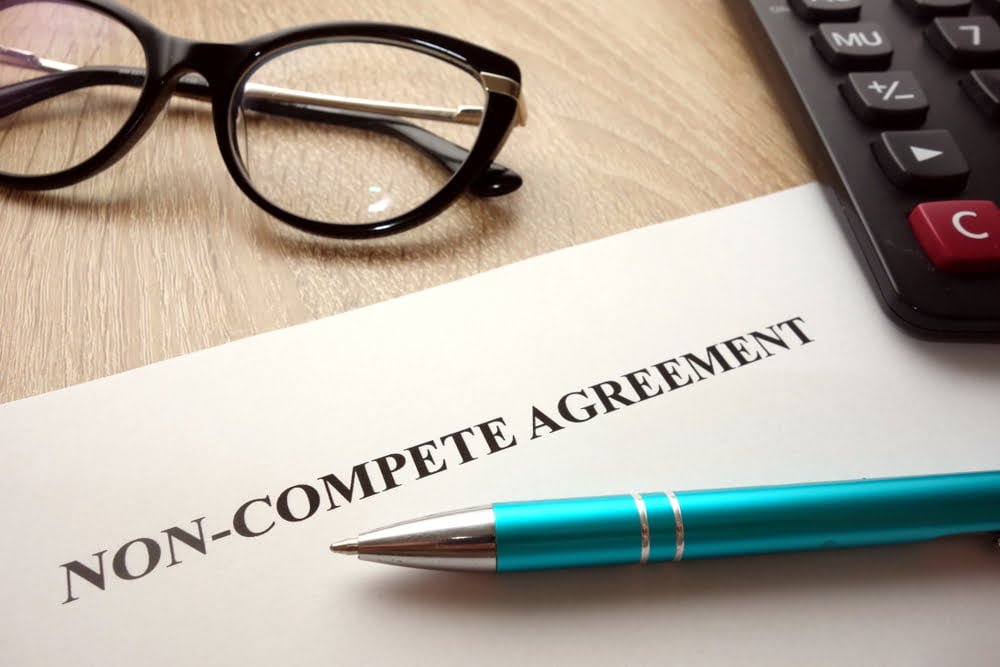 Non-compete agreement document for filling and signing on desk