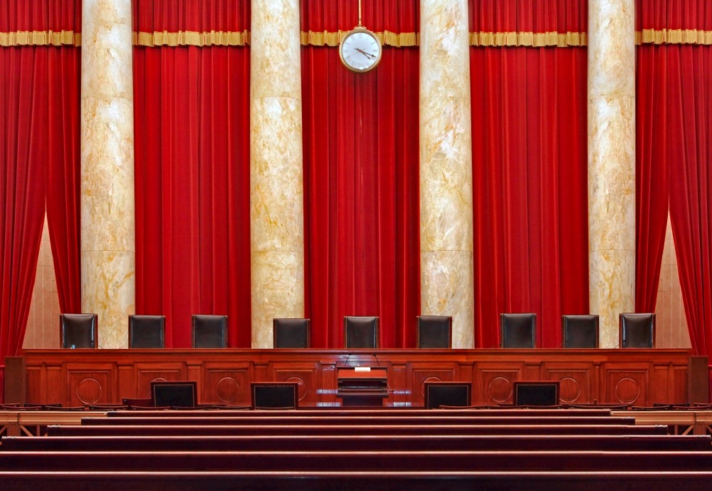 The court room interior at the United States Supreme Court, showing the seats for the nine judges.