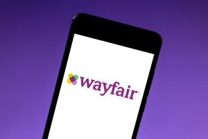Wayfair logo is displayed on a smartphone.