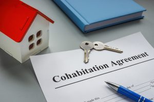 Cohabitation agreement, keys and model of home.