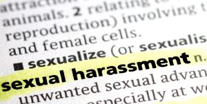 close up photo of the words sexual harassment highlighted on a page in the dictionary