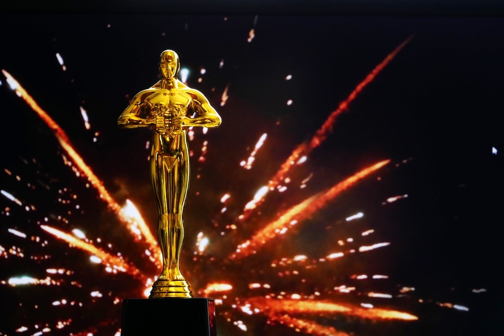Hollywood Golden Oscar Academy award statue on fireworks background