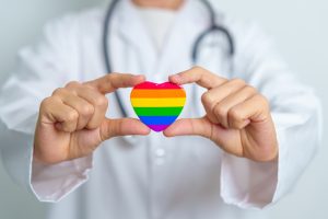 LGBT pride month or LGBTQ+ or LGBTQIA+ and health concept. Doctor with rainbow and colorful heart shape with for Lesbian, Gay, Bisexual, Transgender, Queer and Pansexual community