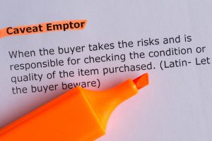 the word Caveat Emptor highlighted and the definition of the word "buyer beware"