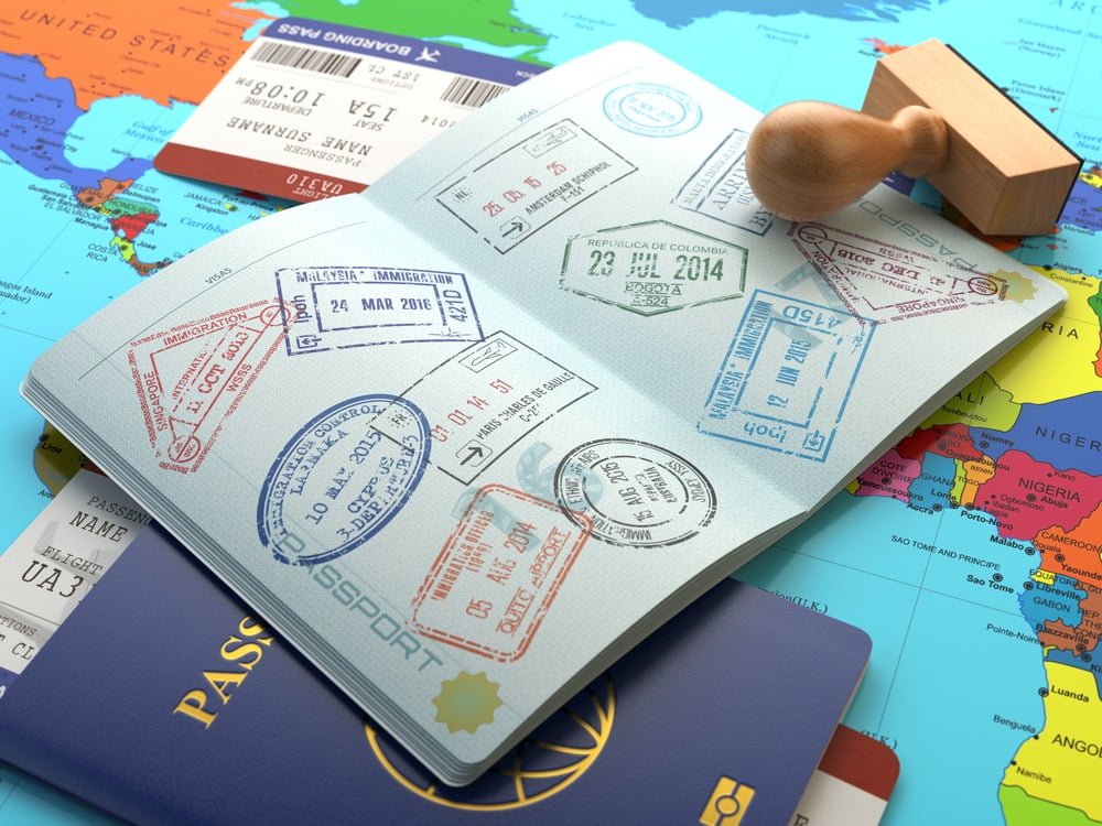 passport book with lots of locations cancelled or stamed out in many colors